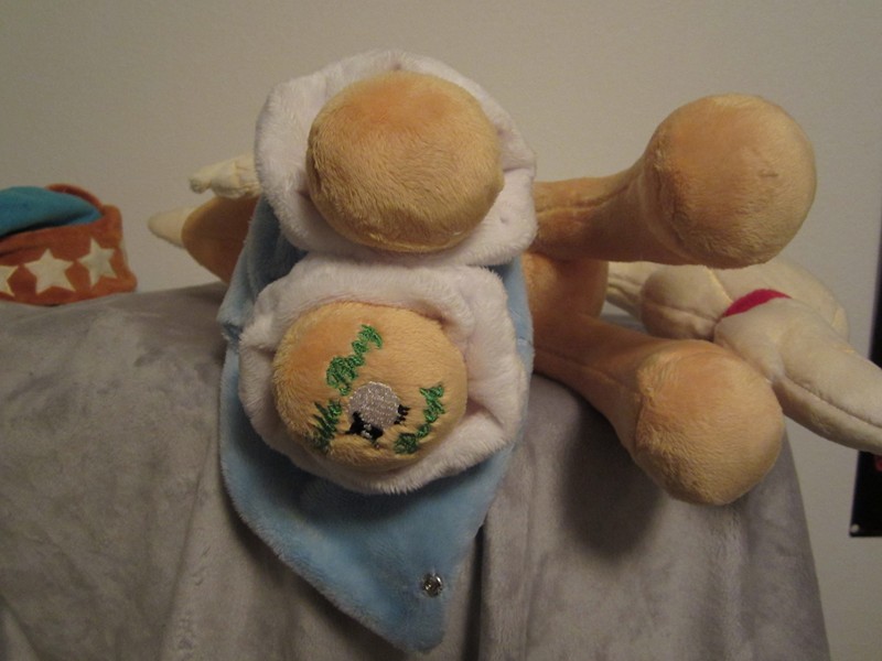 I think it is best to lay the pony on her side and pull her legs through the first part of her dress.